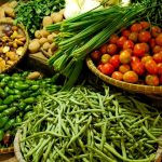 Colorful assortment of fresh vegetables in a local market setting.